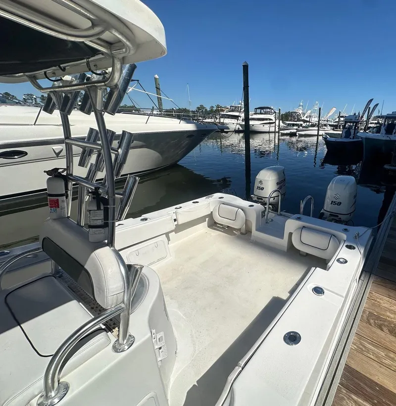 Slide: The Image of 2017 Twin Vee 26 GF boat docked, featuring dual outboard motors and spacious deck. - 11