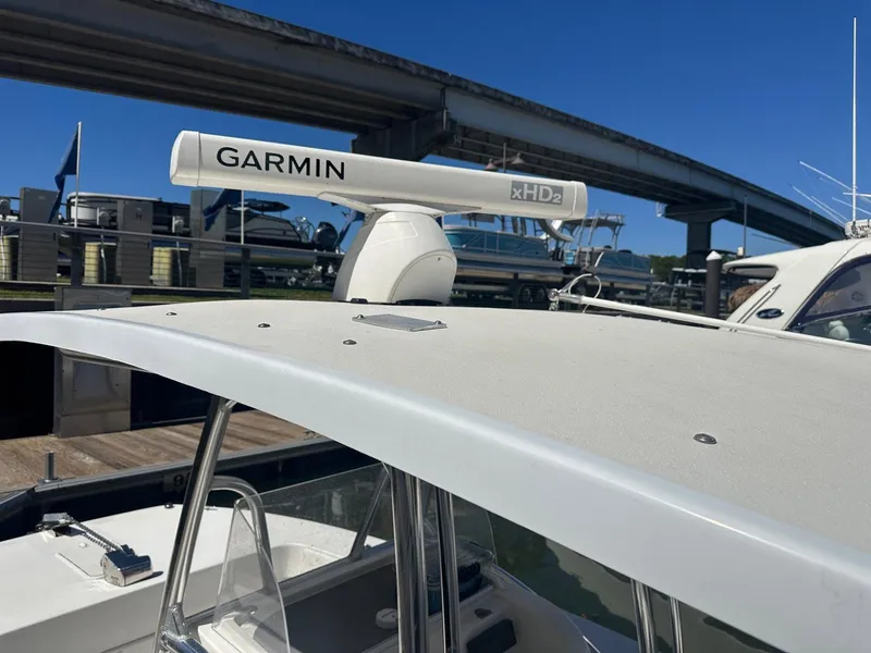 Slide: The Image of 2017 Twin Vee 26 GF boat with Garmin radar under a bridge. - 6