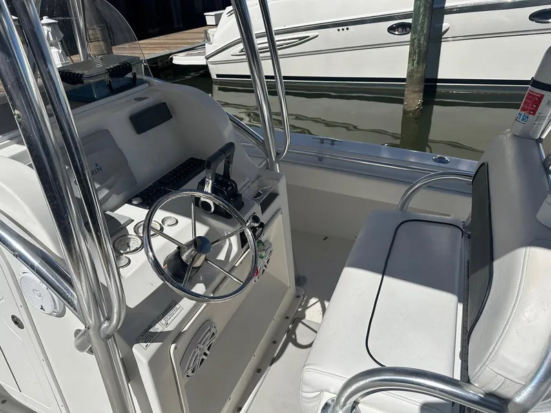 Slide: The Image of 2017 Twin Vee 26 GF boat interior with steering console and seating. - 9