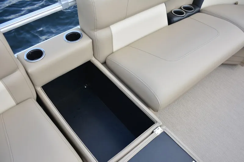 Slide: The Image of 2023 Starcraft LX 16 boat interior with beige seating and storage compartment. - 11