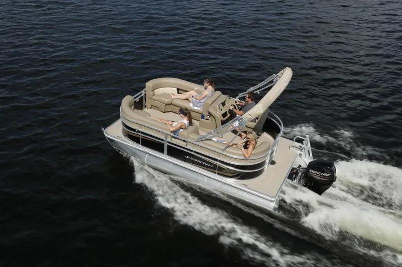 Slide: The Image of 2023 Starcraft LX 16 pontoon boat cruising on water with passengers. - 4