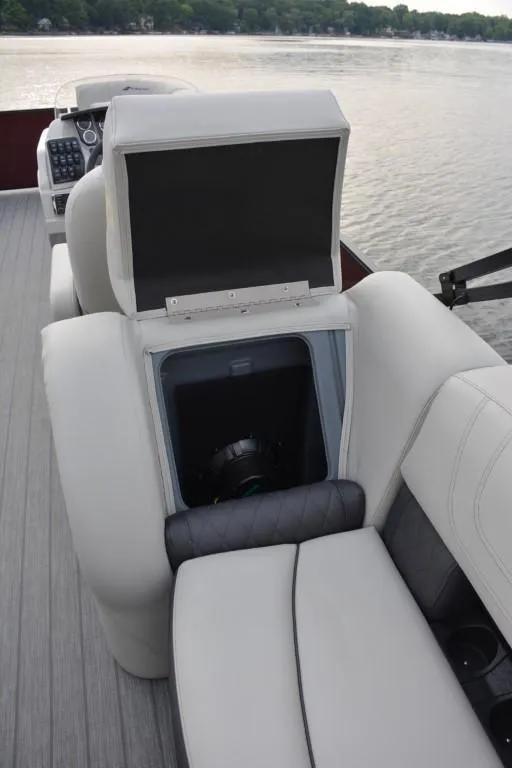 Slide: The Image of 2023 Starcraft SLS 1 boat with open storage compartment on the lake. - 10