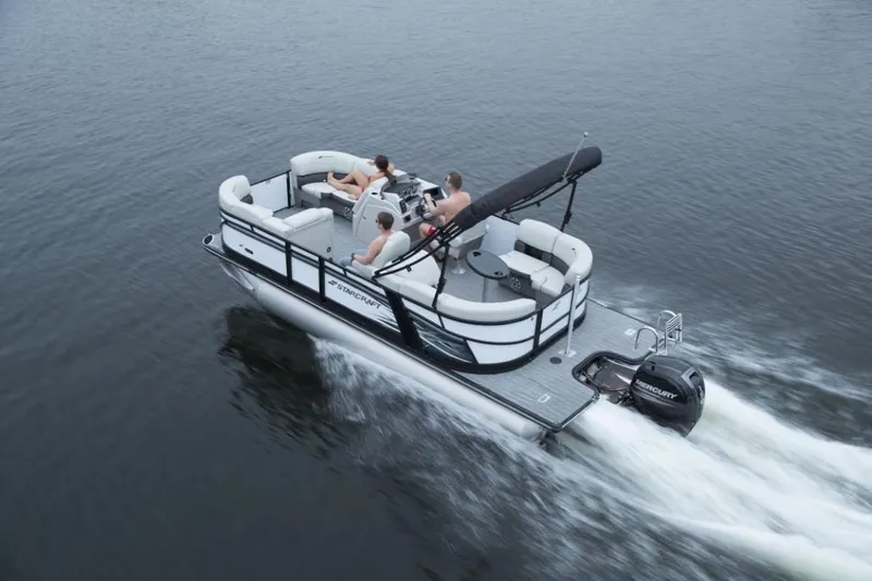 Slide: The Image of 2024 Starcraft SLS 5 pontoon boat cruising on a lake. - 9