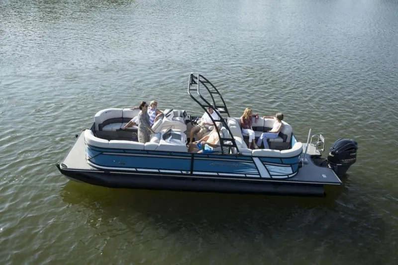 Slide: The Image of 2023 Starcraft SLS 5 pontoon boat on a lake with passengers. - 1