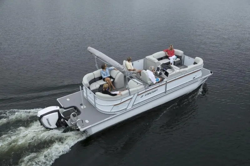 Slide: The Image of 2023 Starcraft SLS 5 pontoon boat cruising on a lake with passengers. - 10