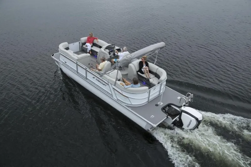 Slide: The Image of 2023 Starcraft SLS 5 pontoon boat cruising on water with passengers. - 12
