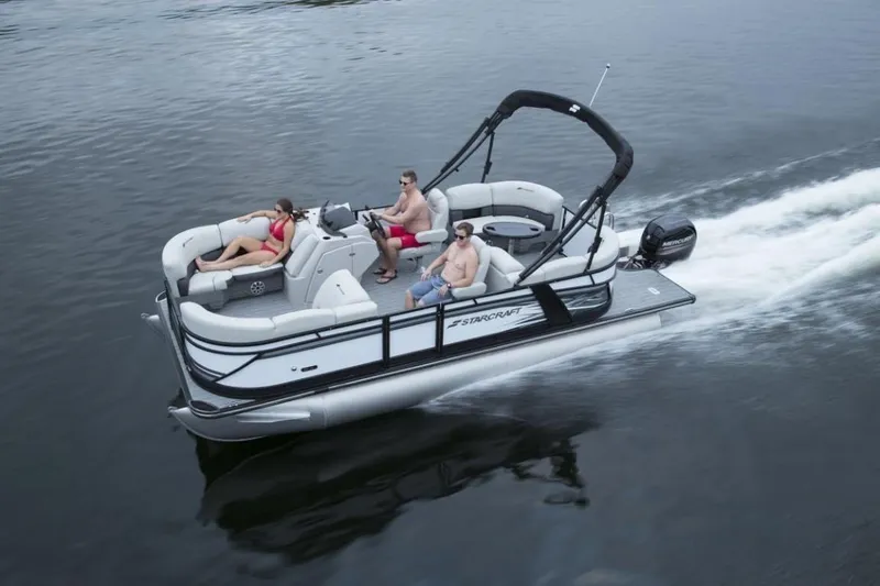 Slide: The Image of 2023 Starcraft SLS 5 pontoon boat cruising on water with passengers. - 7