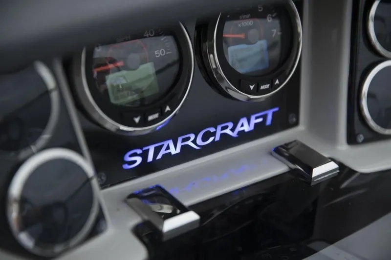 Slide: The Image of 2023 Starcraft SLS 5 dashboard with illuminated logo and gauges. - 8