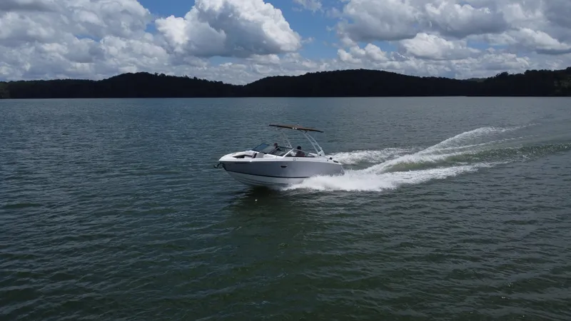 Slide: The Image of 2023 Cobalt R6 boat cruising on a lake under a cloudy sky. - 11