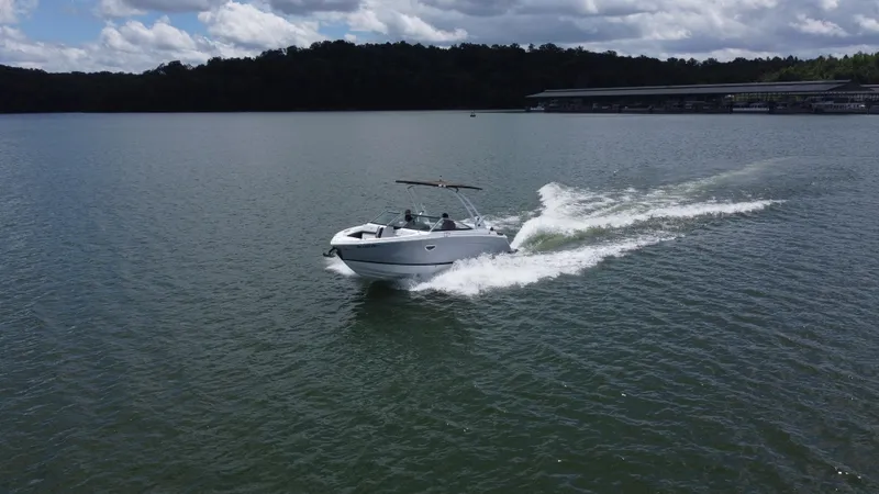Slide: The Image of 2023 Cobalt R6 boat cruising on a lake under a cloudy sky. - 16