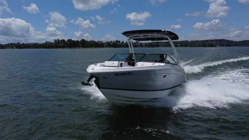 Slide: The Image of 2023 Cobalt R6 boat cruising on a lake under a partly cloudy sky. - 3