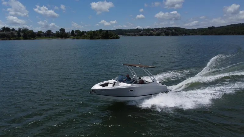 Slide: The Image of 2023 Cobalt R6 boat cruising on a lake under a clear blue sky. - 7