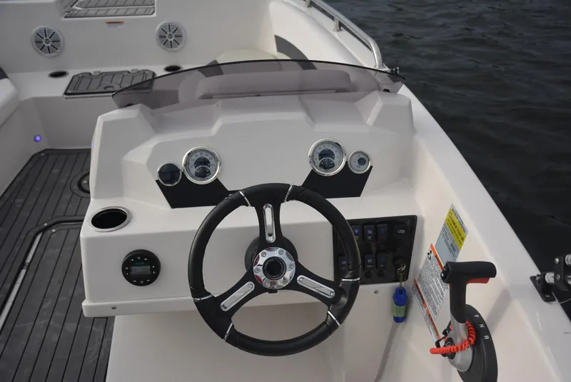 Slide: The Image of 2024 Starcraft SVX 171 boat dashboard with steering wheel and control panel. - 10