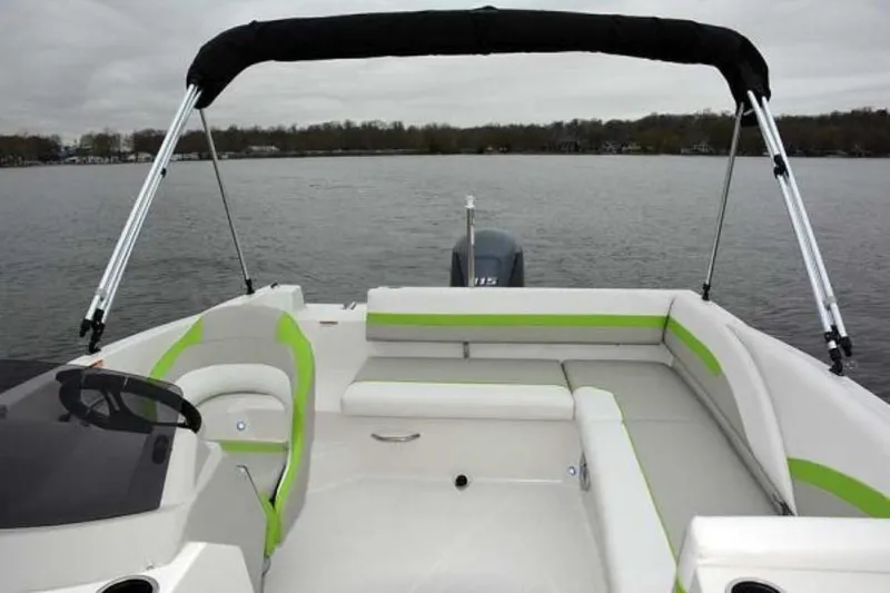 Slide: The Image of 2023 Starcraft SVX 171 boat interior with green and white seating on a lake. - 11
