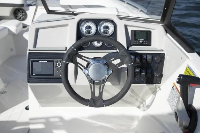 Slide: The Image of 2023 Starcraft SVX 171 boat dashboard with steering wheel and control panels. - 14
