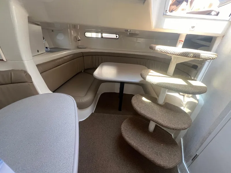 Slide: The Image of 1996 Silverton 310 Express cabin interior with seating, table, and spiral staircase. - 10