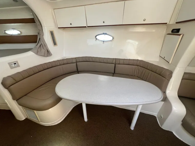 Slide: The Image of 1996 Silverton 310 Express interior with curved seating and table. - 14