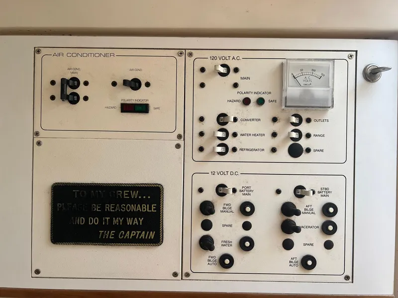 Slide: The Image of Control panel of a 1996 Silverton 310 Express boat with air conditioner and electrical switches. - 17