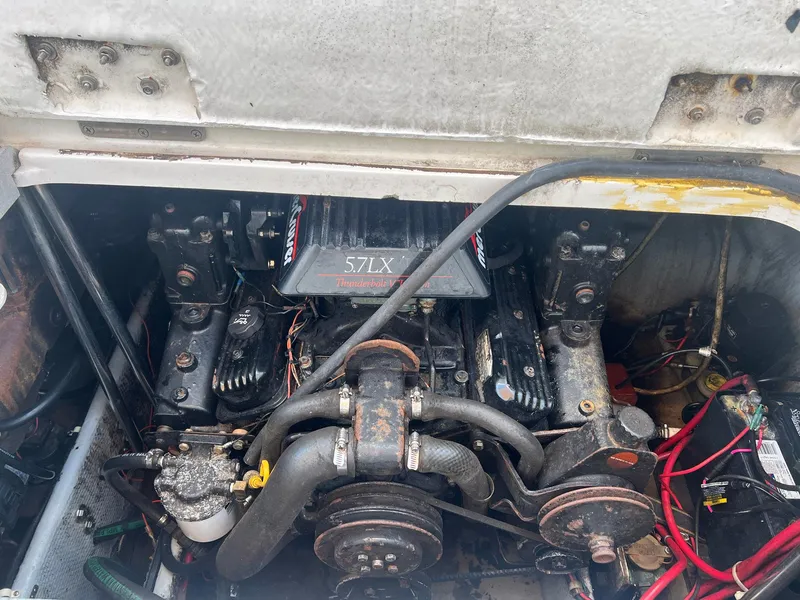 Slide: The Image of Engine compartment of a 1996 Silverton 310 Express boat, featuring a 5.7L engine. - 18