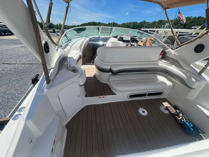 Slide: The Image of 1996 Silverton 310 Express boat interior with white seating and wooden deck. - 4