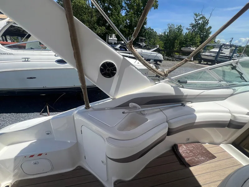 Slide: The Image of 1996 Silverton 310 Express boat interior with seating and speaker, docked outdoors. - 5