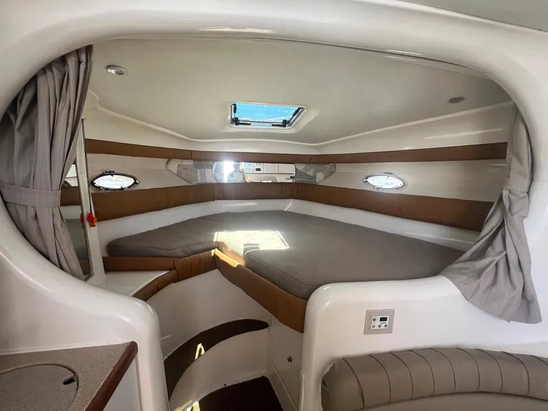 Slide: The Image of 1996 Silverton 310 Express cabin interior with bed, skylight, and portholes. - 7