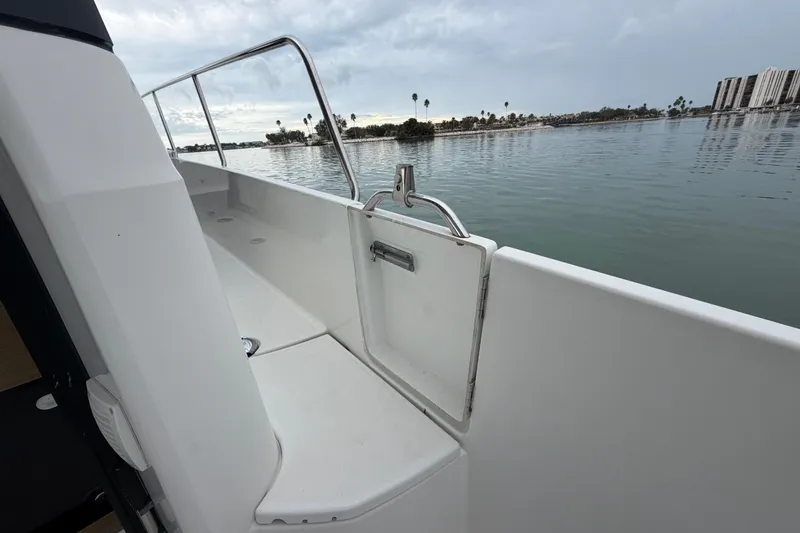 Slide: The Image of 2019 Jeanneau NC 895 boat deck with railing, overlooking calm waters and distant shoreline. - 11