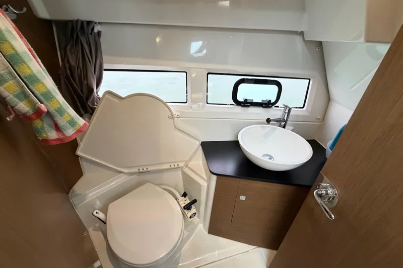 Slide: The Image of 2019 Jeanneau NC 895 bathroom with modern sink, toilet, and window. - 21