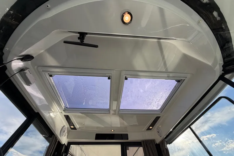 Slide: The Image of Interior view of 2019 Jeanneau NC 895 boat with skylight and ceiling light. - 23