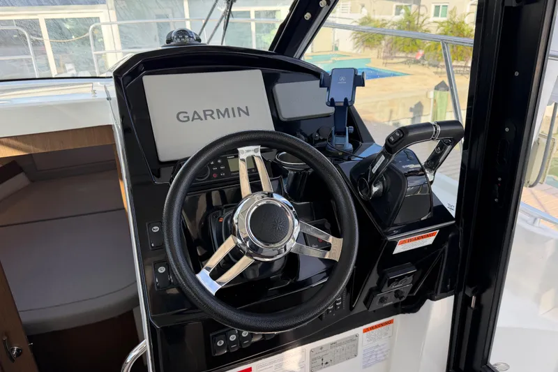 Slide: The Image of 2019 Jeanneau NC 895 helm with Garmin navigation system and steering wheel. - 25