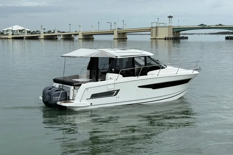 Slide: The Image of 2019 Jeanneau NC 895 boat on calm water near a bridge. - 3