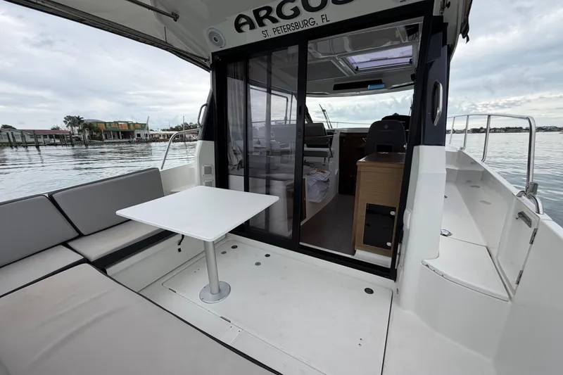 Slide: The Image of 2019 Jeanneau NC 895 boat with seating area and table, docked in St. Petersburg, FL. - 8
