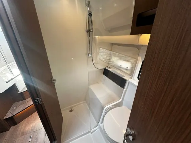 Slide: The Image of 2026 Beneteau Antares 11 Coupe bathroom with shower and toilet. - 10