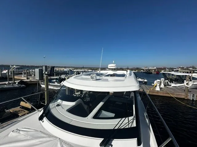 Slide: The Image of Beneteau Antares 11 Coupe 2026 docked under clear sky. - 23