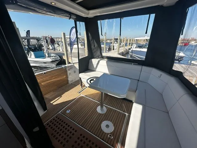 Slide: The Image of Interior of 2026 Beneteau Antares 11 Coupe with seating and table. - 25