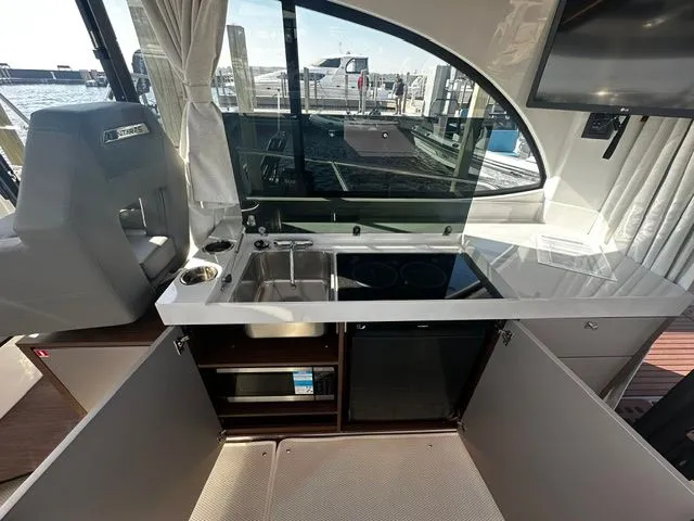 Slide: The Image of Interior of 2026 Beneteau Antares 11 Coupe featuring modern kitchen. - 26