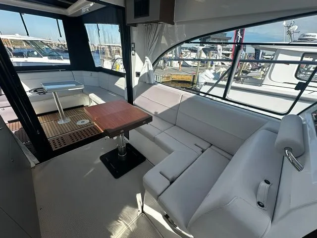 Slide: The Image of Interior of 2026 Beneteau Antares 11 Coupe with elegant seating area. - 27