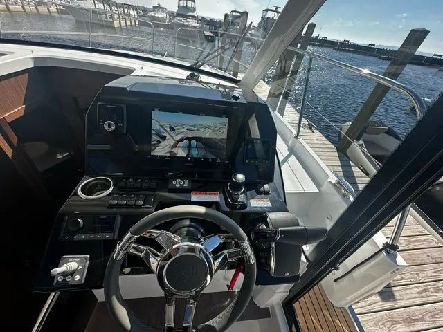 Slide: The Image of Interior view of Beneteau Antares 11 Coupe 2026 cockpit at dock. - 28