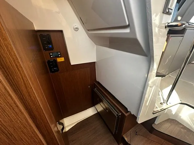 Slide: The Image of Interior of 2026 Beneteau Antares 11 Coupe with wood paneling. - 9