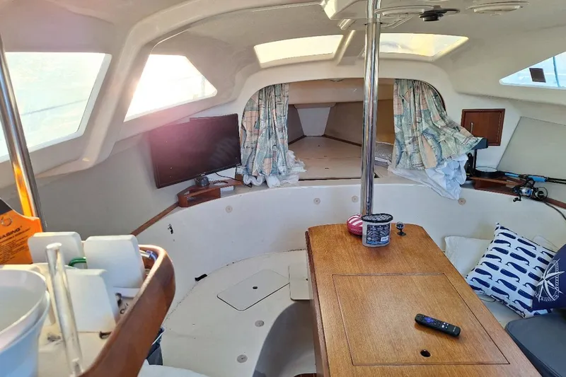 Slide: The Image of Interior of 1995 Hunter 29.5 sailboat with cozy cabin and wooden table. "Amazing Grace " - 4