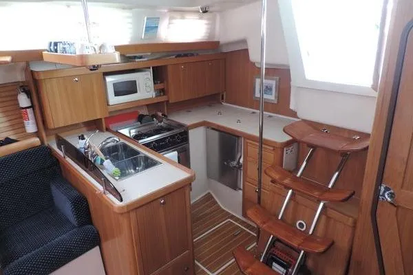 Slide: The Image of Interior of 2008 Catalina 350 MkII yacht with kitchen and wooden cabinetry. - 11