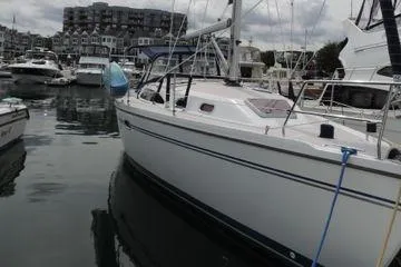 Slide: The Image of 2008 Catalina 350 MkII sailboat docked in a marina with other boats. - 2