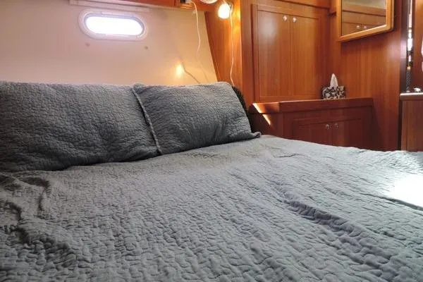 Slide: The Image of Cozy cabin interior of 2008 Catalina 350 MkII with quilted bedding and wooden cabinetry. - 24