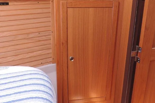 Slide: The Image of Wooden interior of 2008 Catalina 350 MkII sailboat with striped bedding. - 26