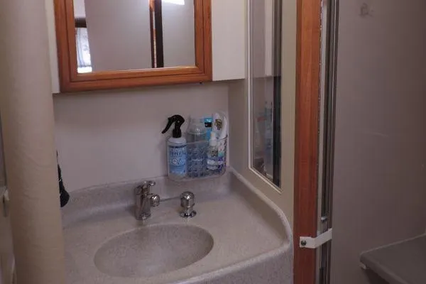 Slide: The Image of Bathroom sink area in 2008 Catalina 350 MkII yacht with mirror and cleaning supplies. - 27