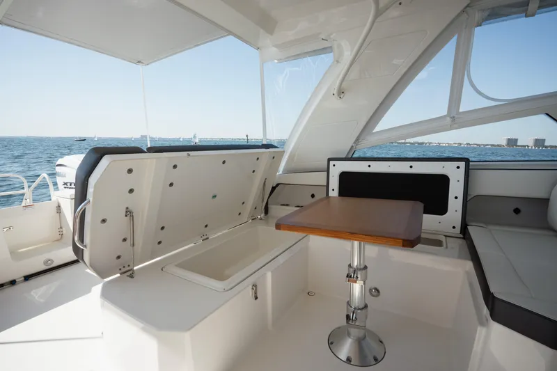 Slide: The Image of 2024 World Cat 400 DC-X boat interior with seating and table, ocean view. - 19