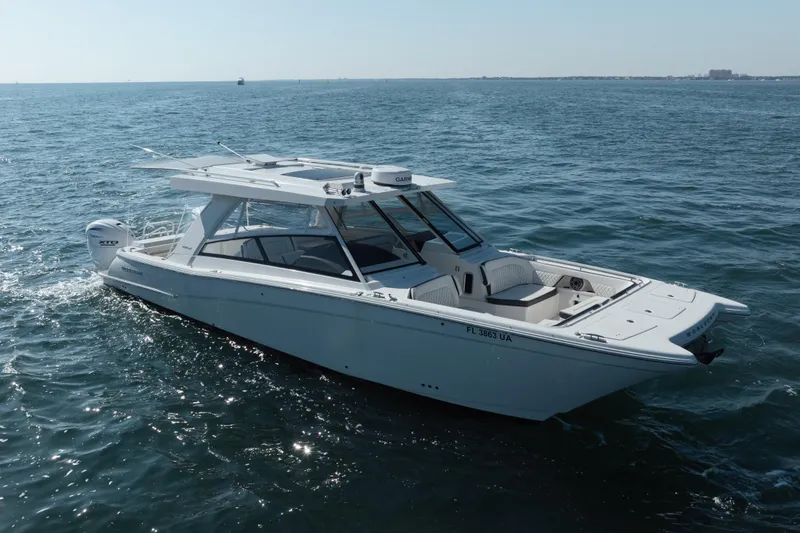 Slide: The Image of 2024 World Cat 400 DC-X boat cruising on open water. - 2