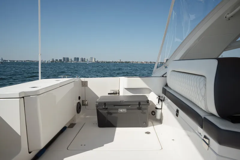 Slide: The Image of 2024 World Cat 400 DC-X boat interior with seating and cooler, ocean view. - 20