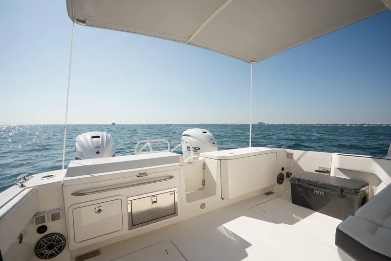 Slide: The Image of 2024 World Cat 400 DC-X boat interior with ocean view, featuring dual engines and seating. - 21