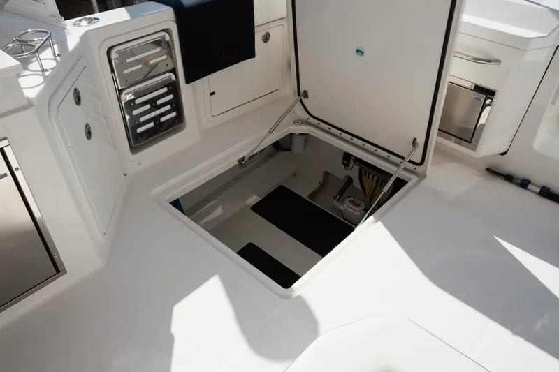 Slide: The Image of 2024 World Cat 400 DC-X boat interior with open storage compartment and sleek design. - 27